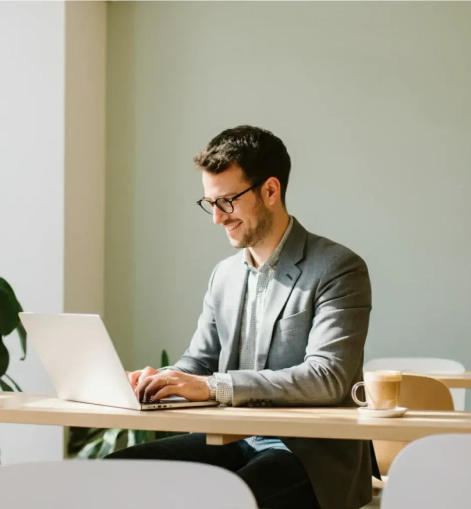 Professional Person typing on laptop at a desk.
